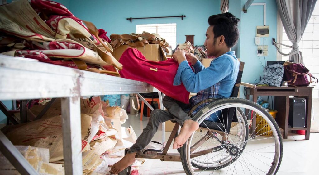 Man in wheelchair crafting bag